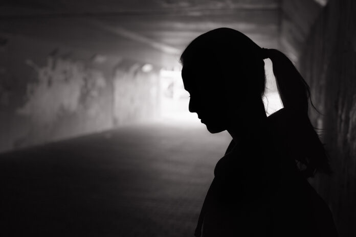 Depressed,Sad,Young,Female,Standing,In,A,Dark,Tunnel